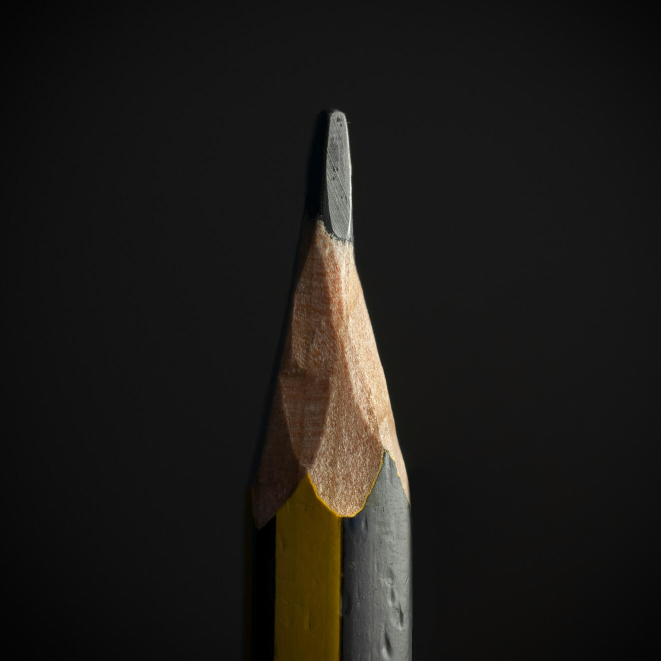 Messaging & Design Close-up of a sharpened pencil against a dark background