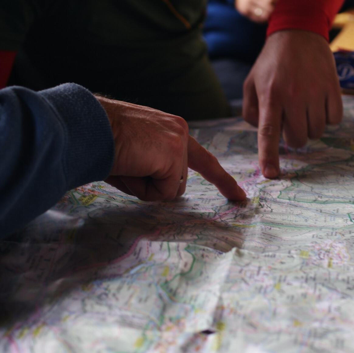 Strategy & Planning Two people pointing at a map while planning a route.
