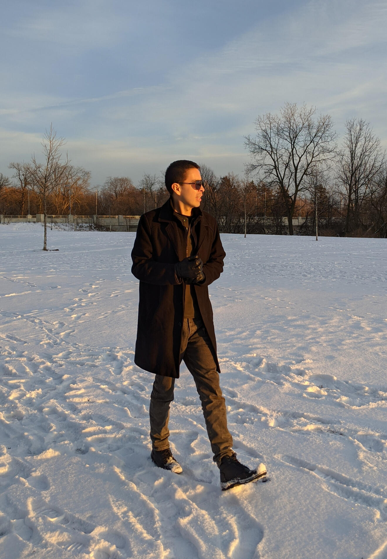 Steve Dinez Steve Dinez walking through a snow-covered park during winter.